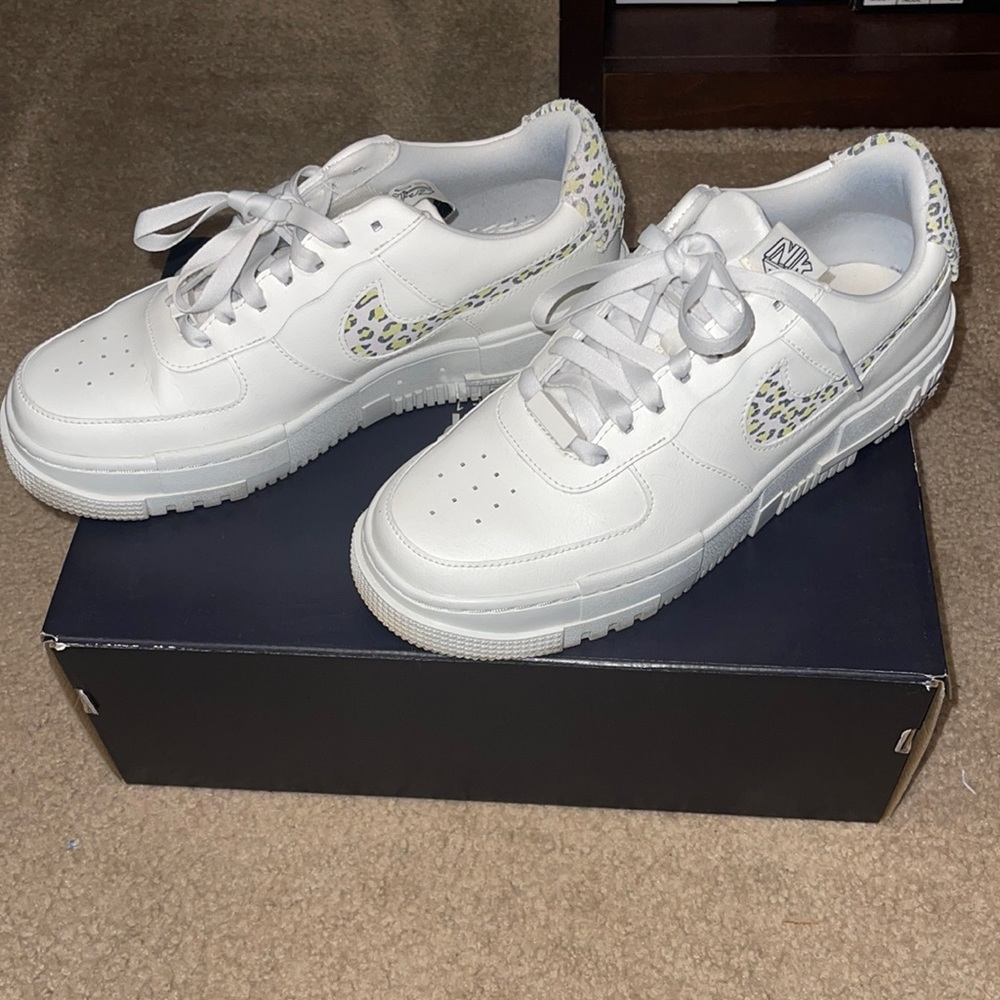Nike Air Force ones with leopard swoosh .